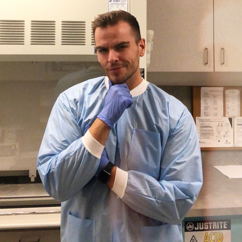 Rob in a robe and rubber gloves, mid-chore