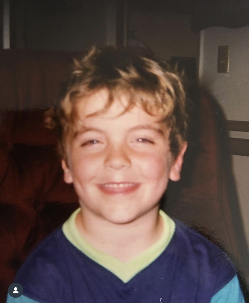 Rob as a freckled kid, grinning