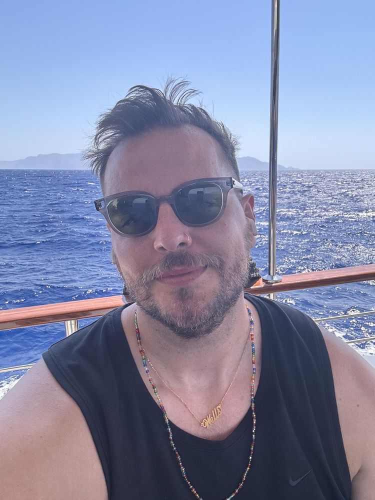 Rob on a sailboat in sunglasses